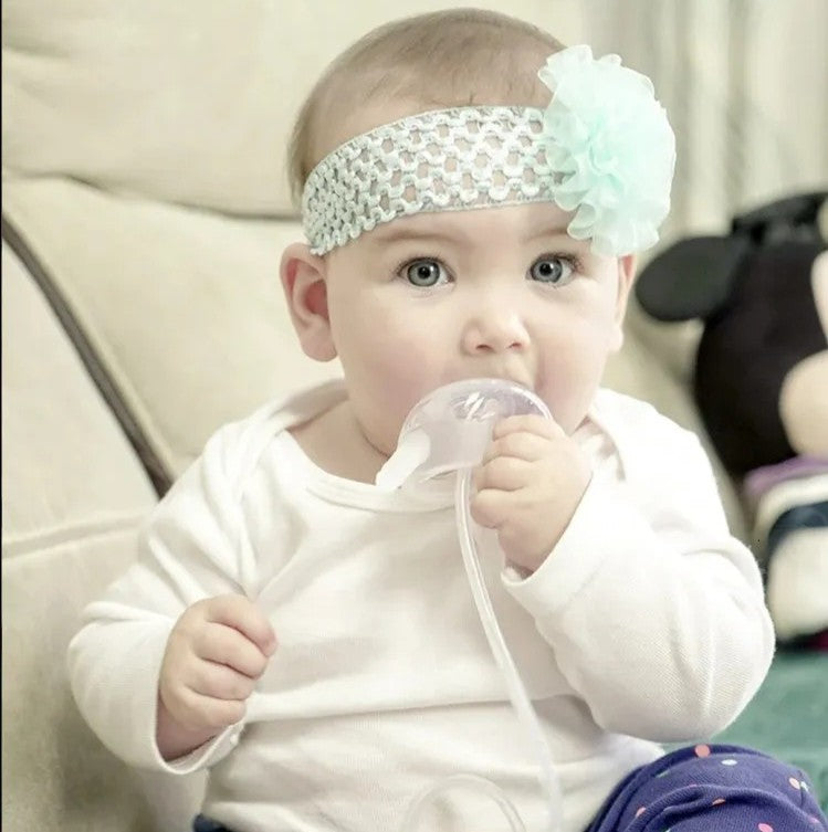 Nuzzle® - Biberón manos libres